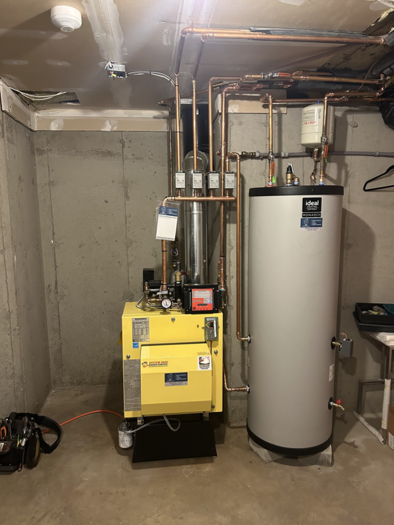 A boiler and hot water tank installation with copper piping by JLP Heating & Cooling in Norwalk, CT