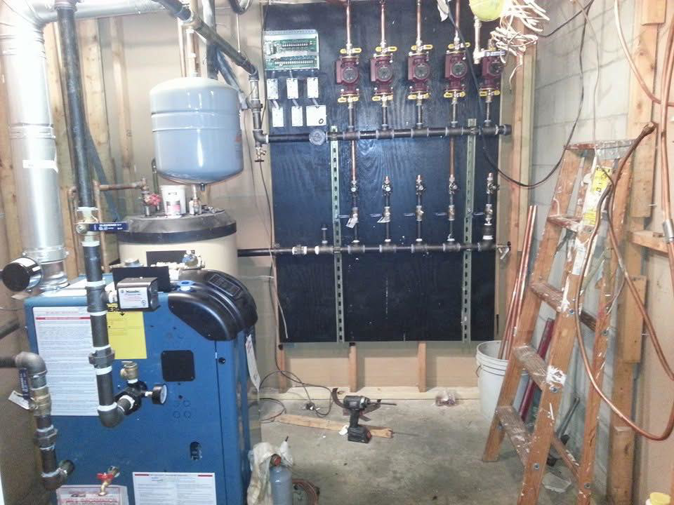 A boiler and hydronic manifold system being installed by Antigua Mechanical, an HVAC contractor in Manchester, NJ.