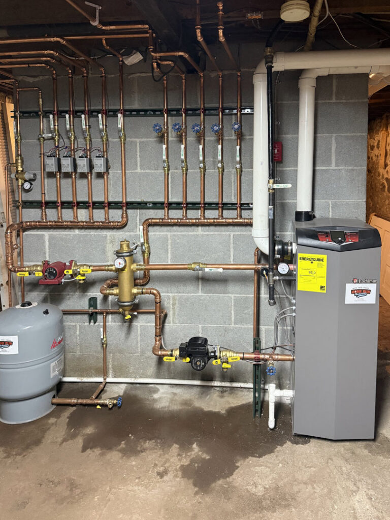 A boiler and intricate hydronic piping system installed by Home Run Mechanical, serving Ann Arbor, MI.