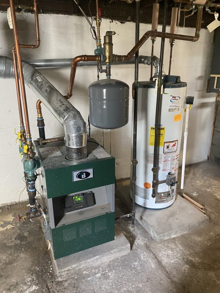 A boiler and water heater installed in a utility area by Kane Heating & Air in Mountain Top, PA.