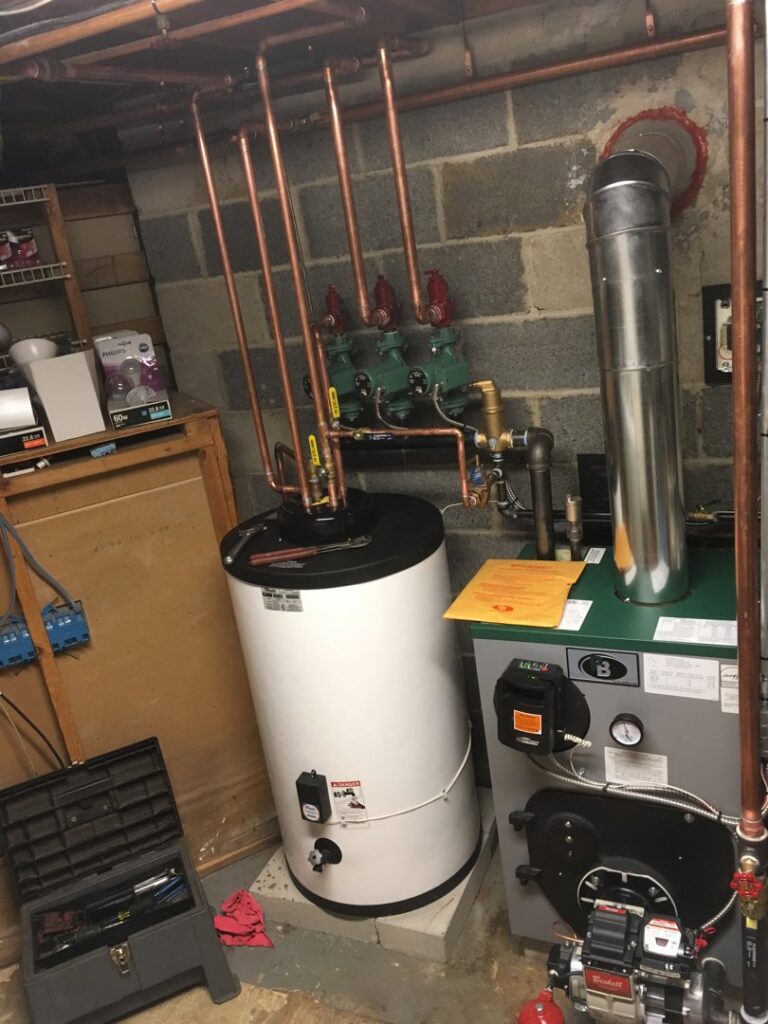 A boiler and white hot water heater installation with copper piping by JLP Heating & Cooling in Norwalk, CT