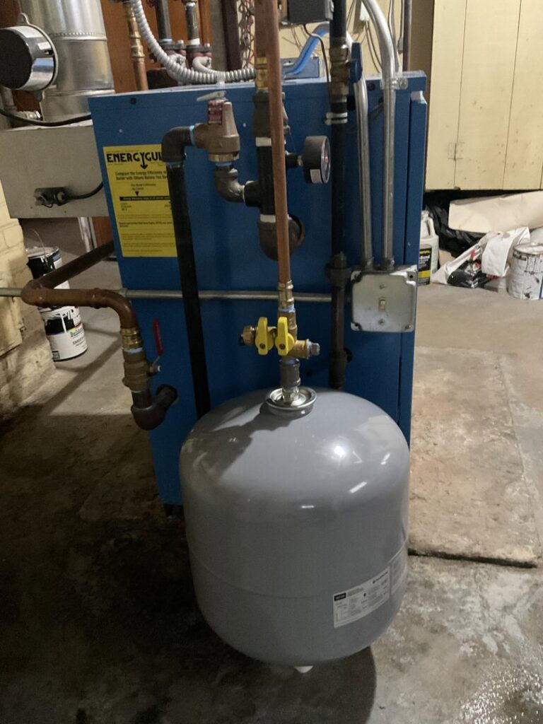 A boiler and expansion tank installed in a utility room by Nimmer Heating & Air Conditioning in Milwaukee, WI.