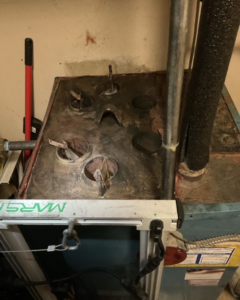 Top view of a boiler or furnace during an inspection or maintenance by Black Oak HVAC in Derry, NH