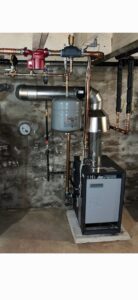 A newly installed boiler or furnace system with copper piping and an expansion tank by Easy Breezy Heating and Air in Florence, KY