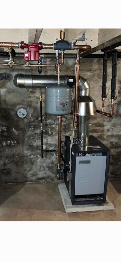 A newly installed boiler or furnace system with copper piping and an expansion tank by Easy Breezy Heating and Air in Florence, KY