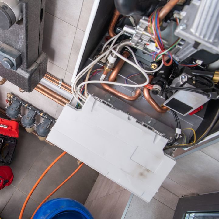 Internal components of a boiler or furnace being serviced by All The Way Heating & Cooling in Middleburgh, NY