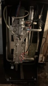 Detailed view of internal components, wiring, and pipes of a boiler or furnace during service by Alpine Pro Solutions in Allentown, PA.