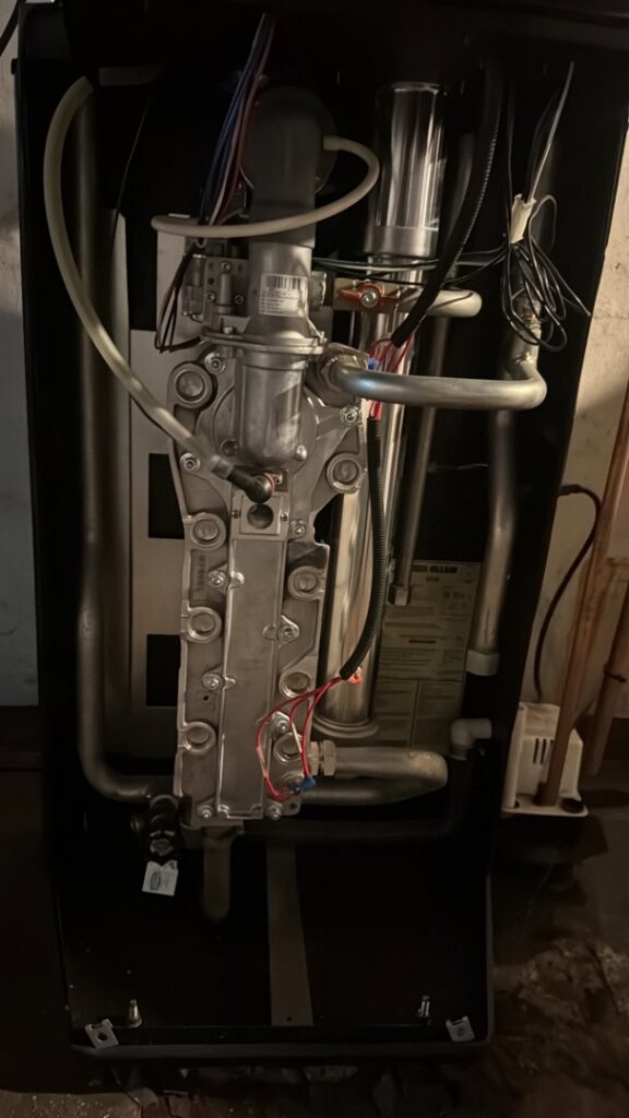 Detailed view of internal components, wiring, and pipes of a boiler or furnace during service by Alpine Pro Solutions in Allentown, PA.