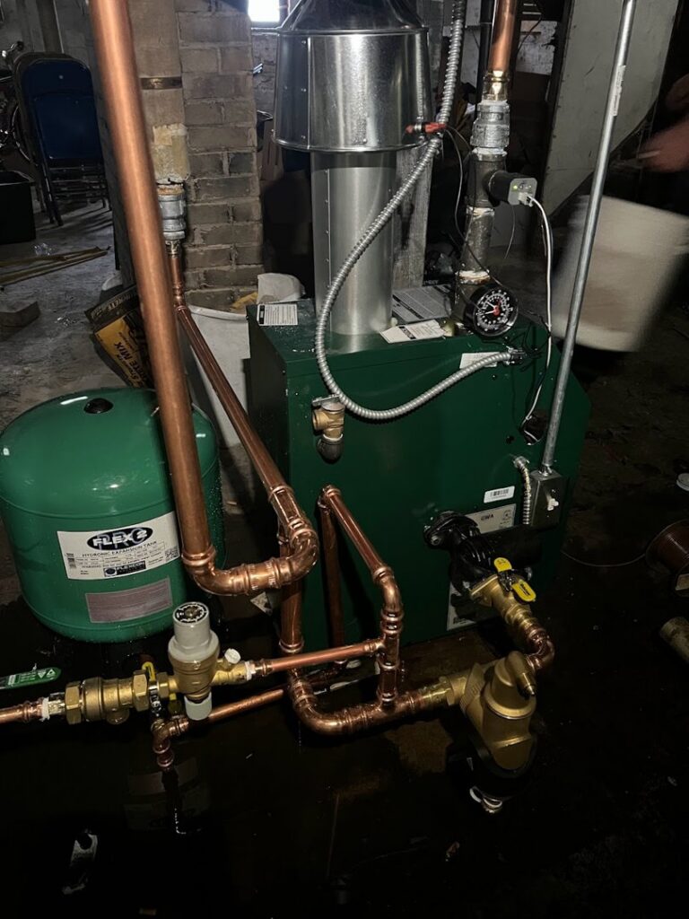 A boiler or furnace with copper piping and an expansion tank installed by Done Right Air in West Allis, WI