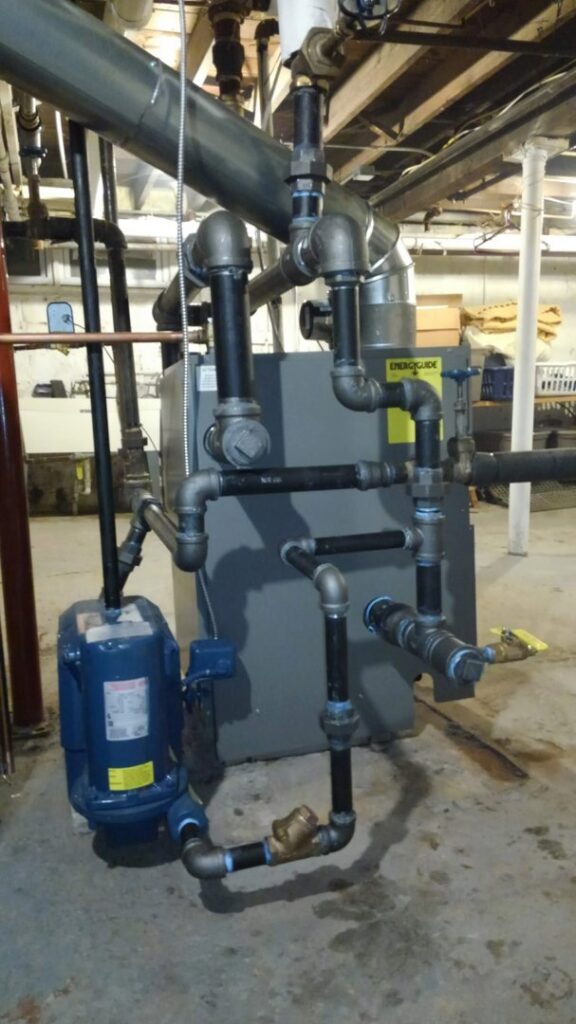 A boiler or furnace system with extensive black iron piping installed by Falso Service Experts in East Syracuse, NY.