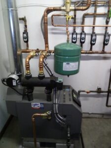 A boiler heating system with copper piping and multiple zone controls installed by Pugh Heating & Air Conditioning in Holland, OH.