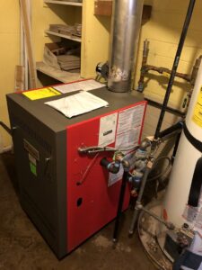 A boiler heating system installation with various pipes and connections by Peterson Heating & Cooling in Mound City, KS.