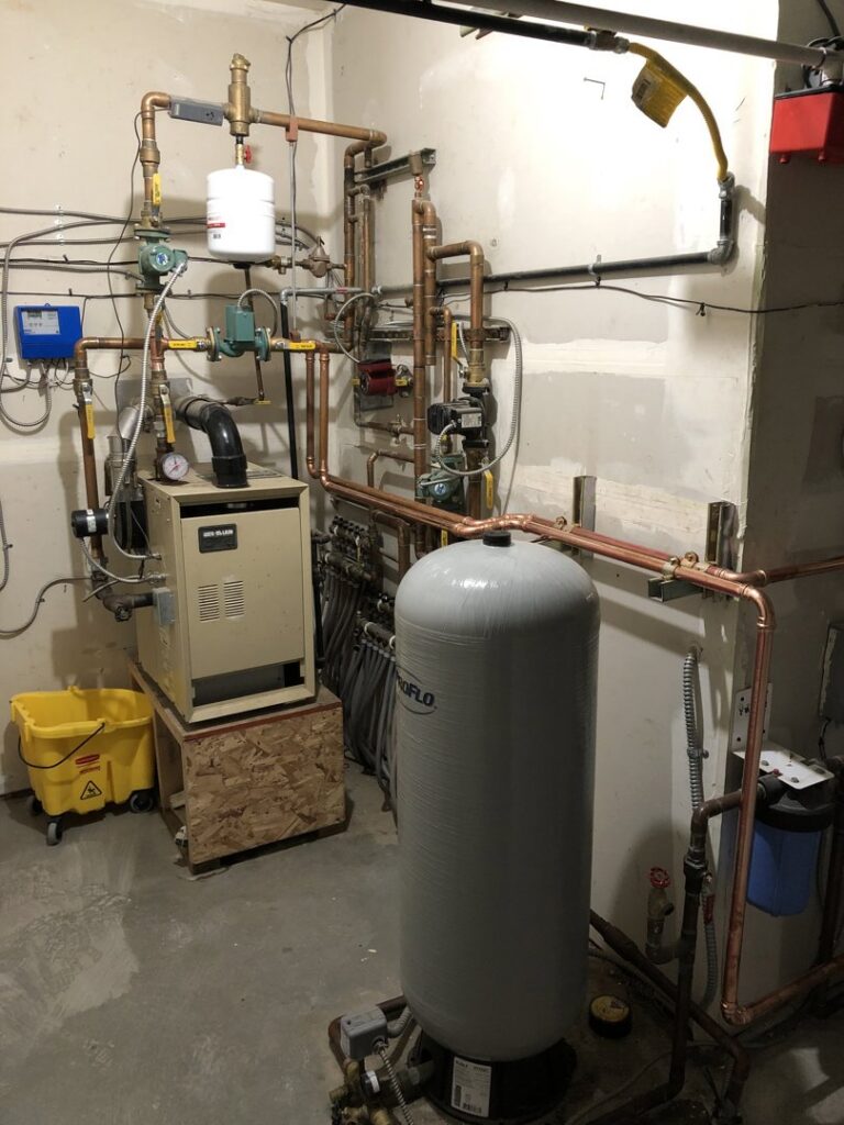 A complete boiler and heating system installation in a utility room by Q1 Mechanical Services, LLC in Wasilla, AK