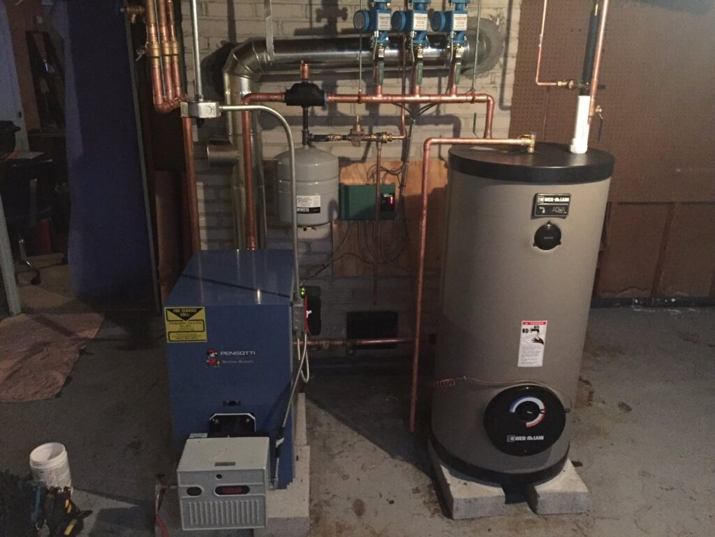 A new boiler and hot water heater installation with detailed piping by Evergreen Services in Warwick, RI.