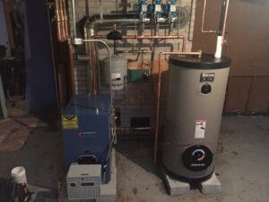 A new boiler and hot water heater installation with detailed piping by Evergreen Services in Warwick, RI.