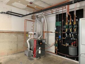 A complex boiler and hydronic heating system with copper piping installed by Elite Heating and Cooling in Livonia, MI.