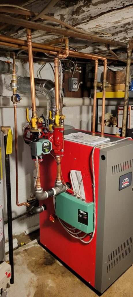 A boiler with new copper piping, indicating a heating system installation or repair by JJJ Techs Heating and Cooling in Kinzers, PA.