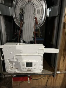 Close-up of boiler interior components during service by Country Suburban Heating & Air Conditioning & Sons, Inc. in Utica, NY.