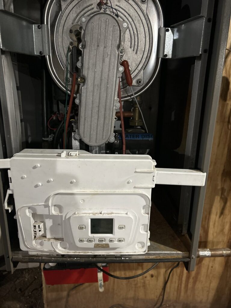 Close-up of boiler interior components during service by Country Suburban Heating & Air Conditioning & Sons, Inc. in Utica, NY.