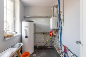 A modern boiler room with a water heater and heating system installation by Terry Allen Plumbing & Heating in Flint, MI.