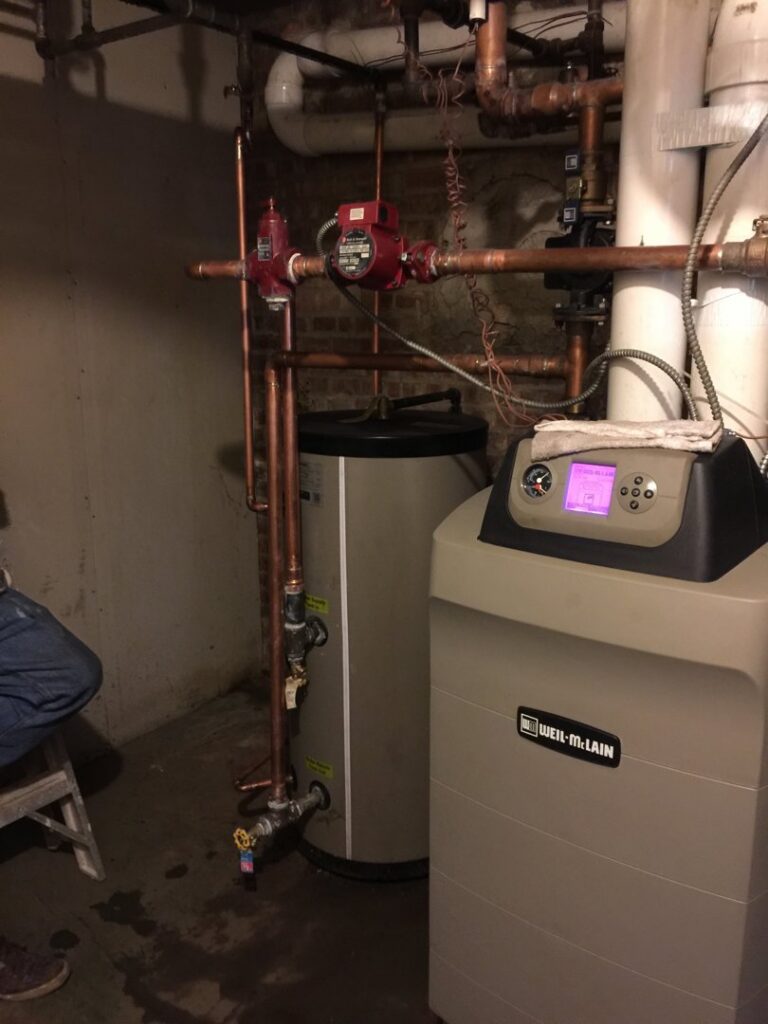 A boiler system and water heater with extensive piping, demonstrating heating system expertise from Around The Town Heating and Cooling in Chicago, IL.