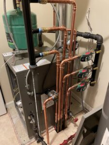 A complex boiler or water heater system with new copper piping and valves installed by Crain Heating and Cooling in Jeffersonville, IN.