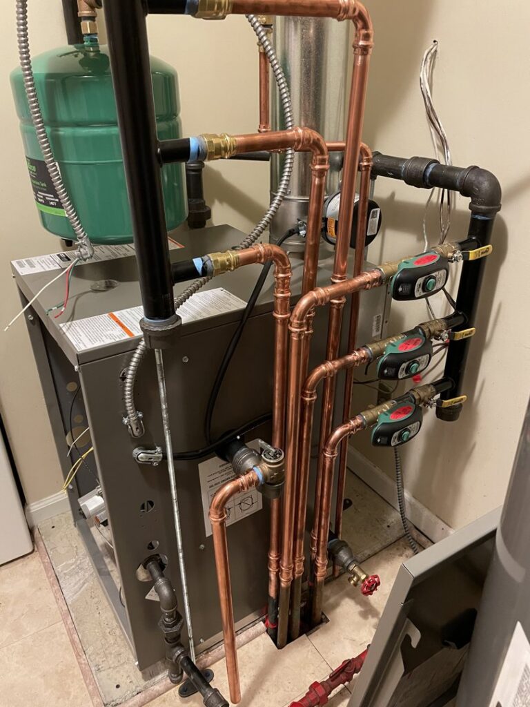 A complex boiler or water heater system with new copper piping and valves installed by Crain Heating and Cooling in Jeffersonville, IN.