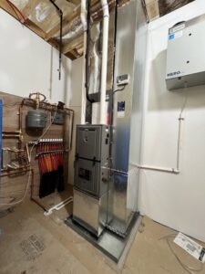 A complex boiler and heating distribution system installed in a utility room by Adam's HVAC in Naperville, IL.