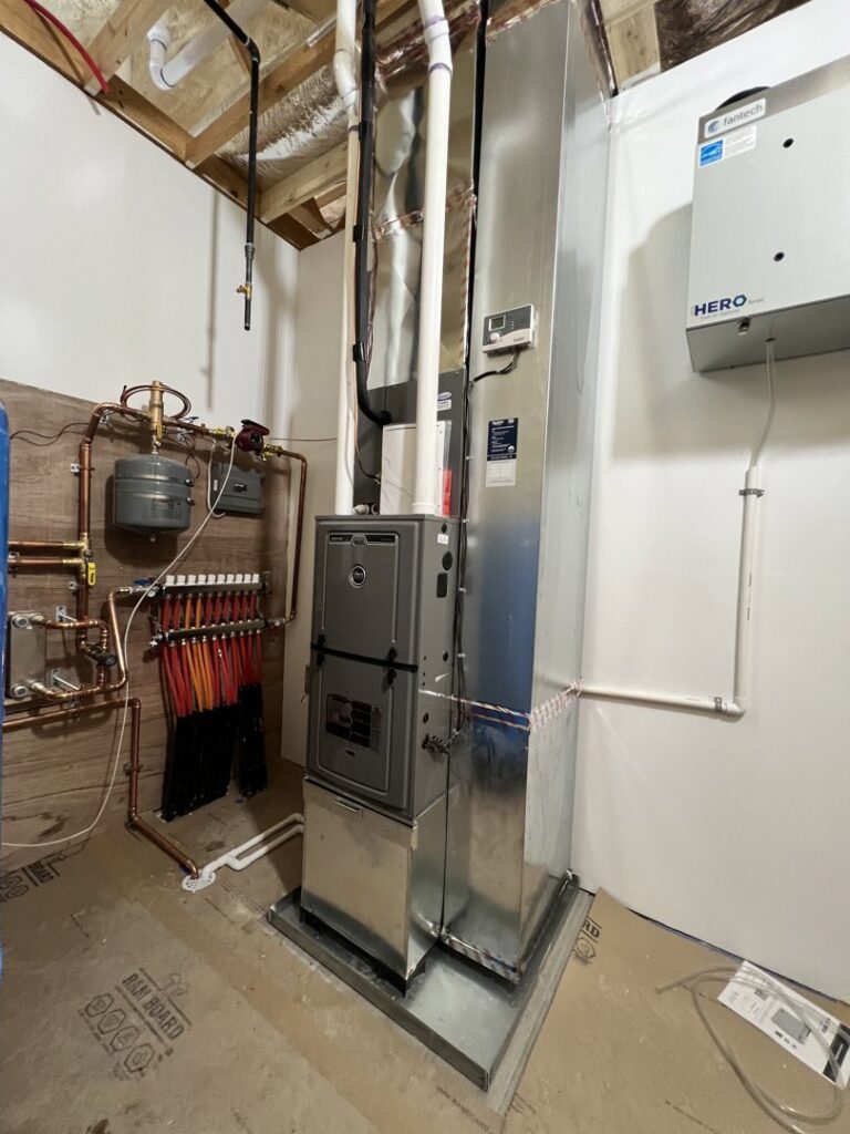 A complex boiler and heating distribution system installed in a utility room by Adam's HVAC in Naperville, IL.
