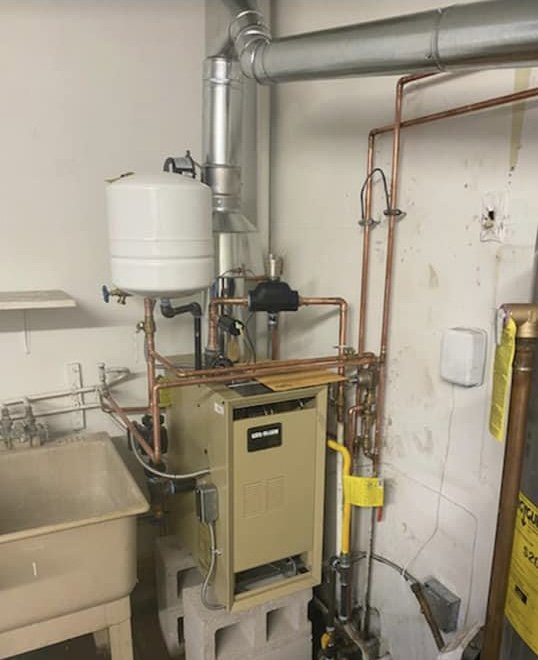 A new boiler system with copper piping and an expansion tank installed by Air We Are in Toms River, NJ.