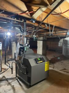 A modern boiler system with intricate copper piping installed in a basement by National Heating & Cooling Company in Lakewood, CO.