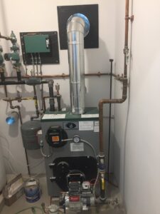 A detailed view of a boiler system installation with copper piping by JLP Heating & Cooling in Norwalk, CT
