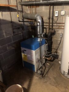 A complete boiler system and water heater installation in a utility room by Ohio City Heating and Cooling in Cleveland, OH.