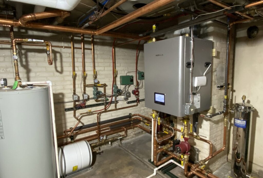 A comprehensive boiler and water heater system with intricate copper piping installed by 9-1-1 Heating & Air, LLC in Milwaukee, WI.