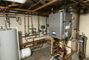 A comprehensive boiler and water heater system with intricate copper piping installed by 9-1-1 Heating & Air, LLC in Milwaukee, WI.