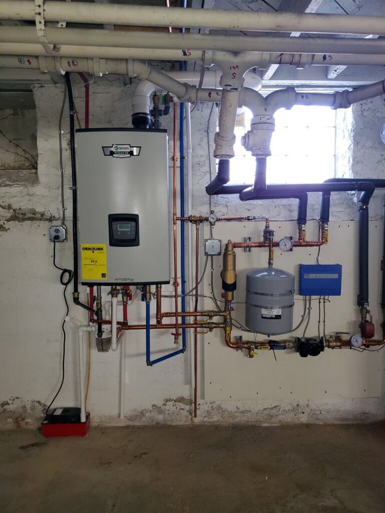 A complex boiler and water heater system with extensive piping installed by Bouvy Heating & Air Conditioning Services in Pittsburgh, PA.