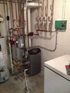 A comprehensive boiler and water heater system with intricate piping, installed by Crain Heating and Cooling in Jeffersonville, IN.