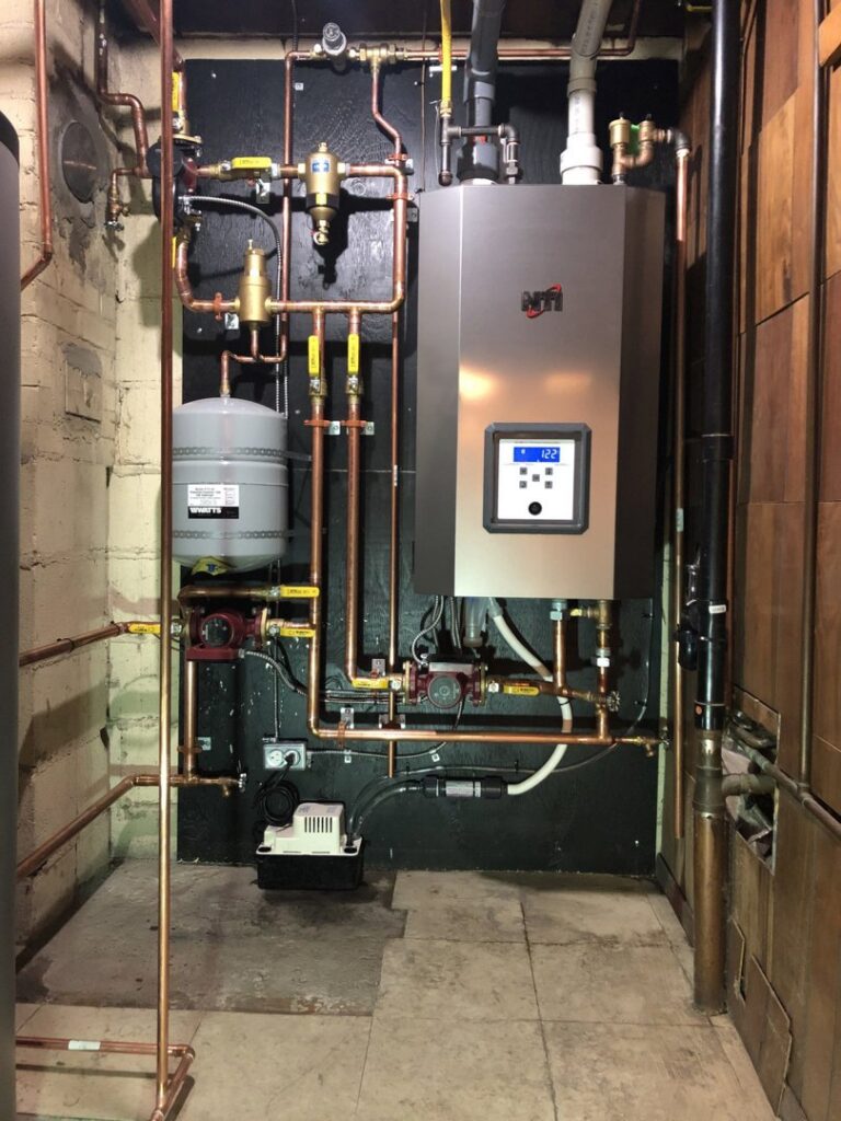 A complex boiler and water heater system with extensive copper piping, installed by Furnace Doctors Heating & Air Conditioning LLC in Champaign, IL