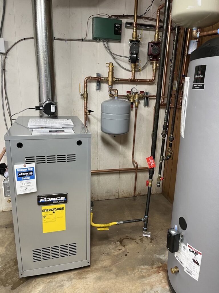 A boiler and water heater system with intricate copper piping installed by True Heating and Cooling in Westminster, CO.