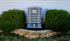 A Bosch outdoor air conditioning unit professionally installed next to a home by Kerley Heating & Cooling in Rock City, IL