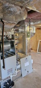 An open Bosch HVAC furnace unit being installed or serviced by Ultra Installs in Barrington, NH