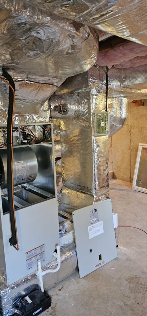 An open Bosch HVAC furnace unit being installed or serviced by Ultra Installs in Barrington, NH