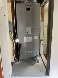 A Bosch indoor air handler unit being installed in a utility closet by McGuffee's Air Conditioning and Heating in Gulfport, MS