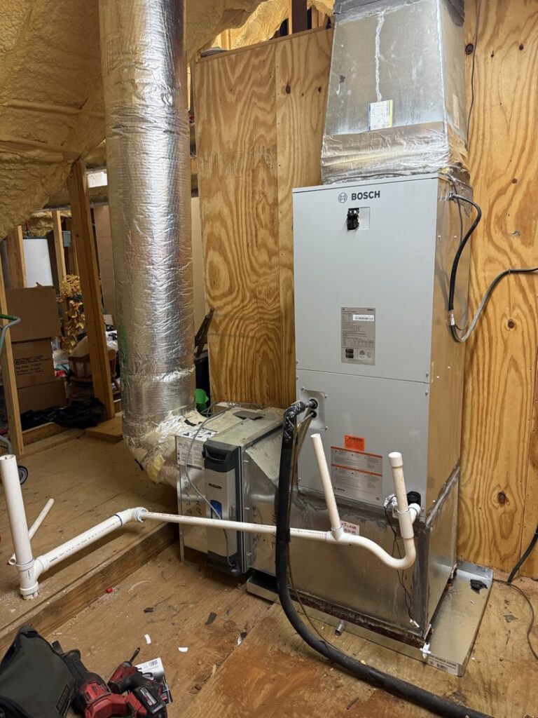 A Bosch indoor HVAC furnace and air handler unit with ductwork installed by Emergency Air in Chandler, AZ.