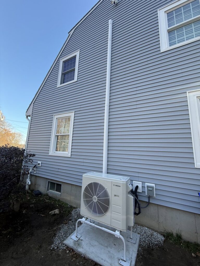 A Bosch mini-split outdoor condenser unit installed on a raised stand by Revolution HVAC in Owings Mills, MD.