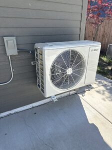 A Bosch mini-split outdoor unit installed on the side of a building by Total HVAC - Heating and Cooling in Nashville, TN.