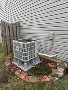 A Bosch outdoor AC unit installed next to a house by Breezy Brothers Heating and Cooling in Lafayette, IN.