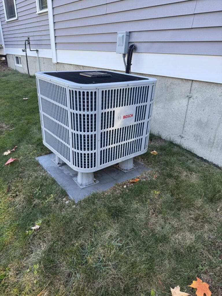 A Bosch outdoor air conditioning unit installed on a raised stand by Revolution HVAC in Owings Mills, MD.