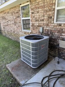 A new Bosch outdoor HVAC condenser unit installed next to a brick home by Emergency Air in Chandler, AZ.