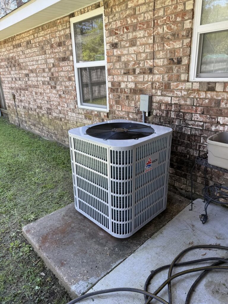 A new Bosch outdoor HVAC condenser unit installed next to a brick home by Emergency Air in Chandler, AZ.